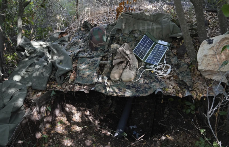 Israeli soldiers display to the media what they say is Hezbollah gear found during their ground operation in southern Lebanon, near the border with Israel, Sunday, Oct. 13, 2024